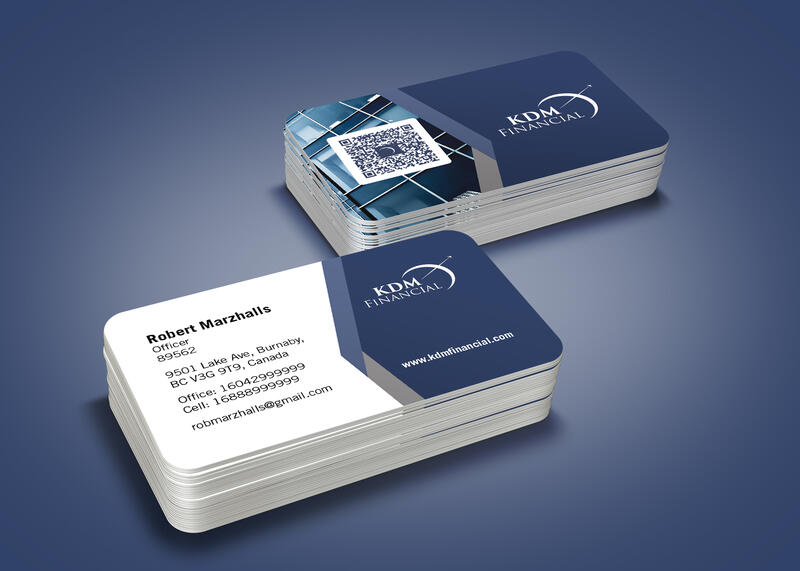 Two stacks of KDM Financial business cards on a navy surface, front and back