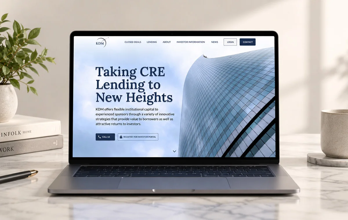 KDM lending website on a laptop: the headline Taking CRE Lending to New Heights over a glass tower, with calls to call the firm or register for the investor portal